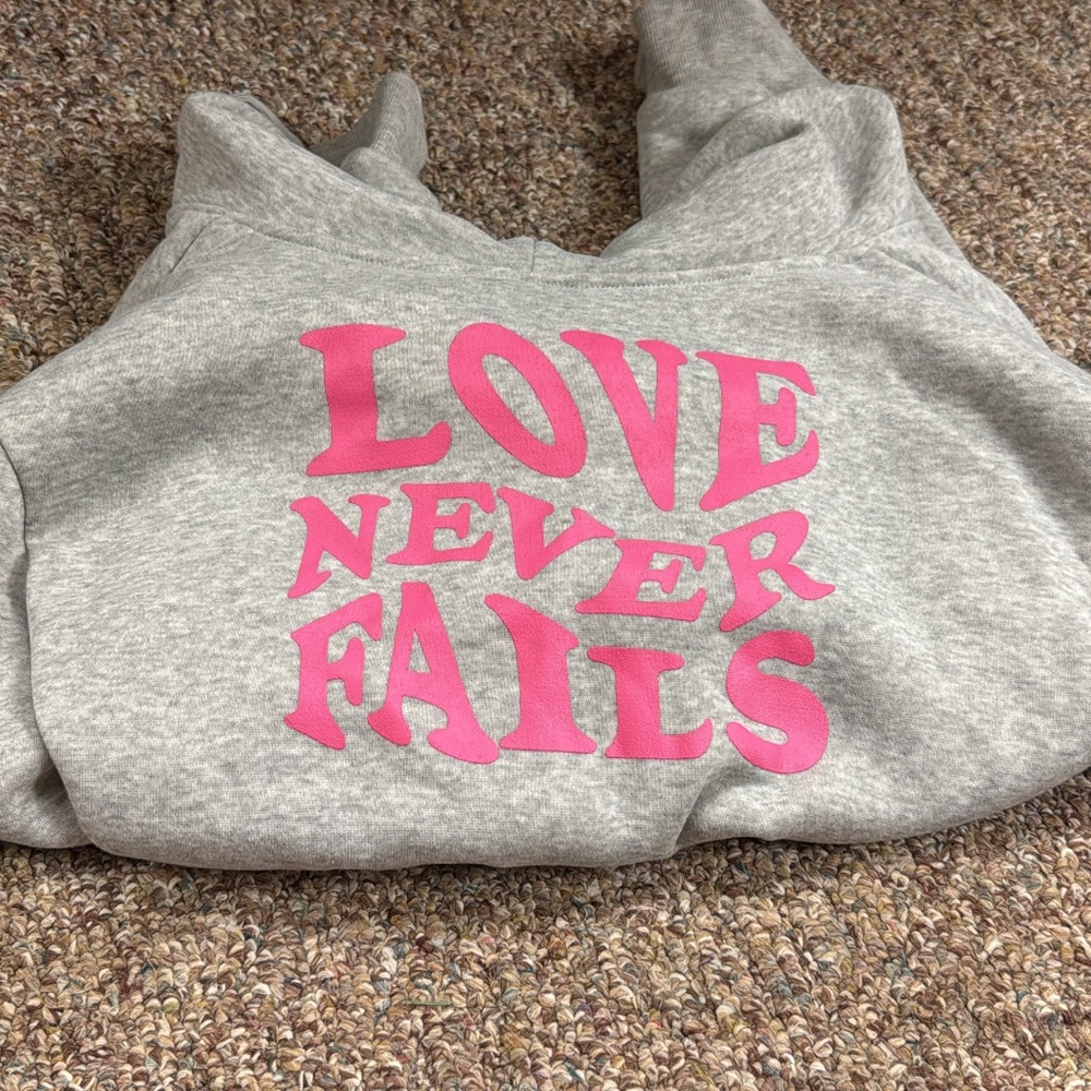 Gray Hoodie with Pink 'Love Never Fails' Print cropped